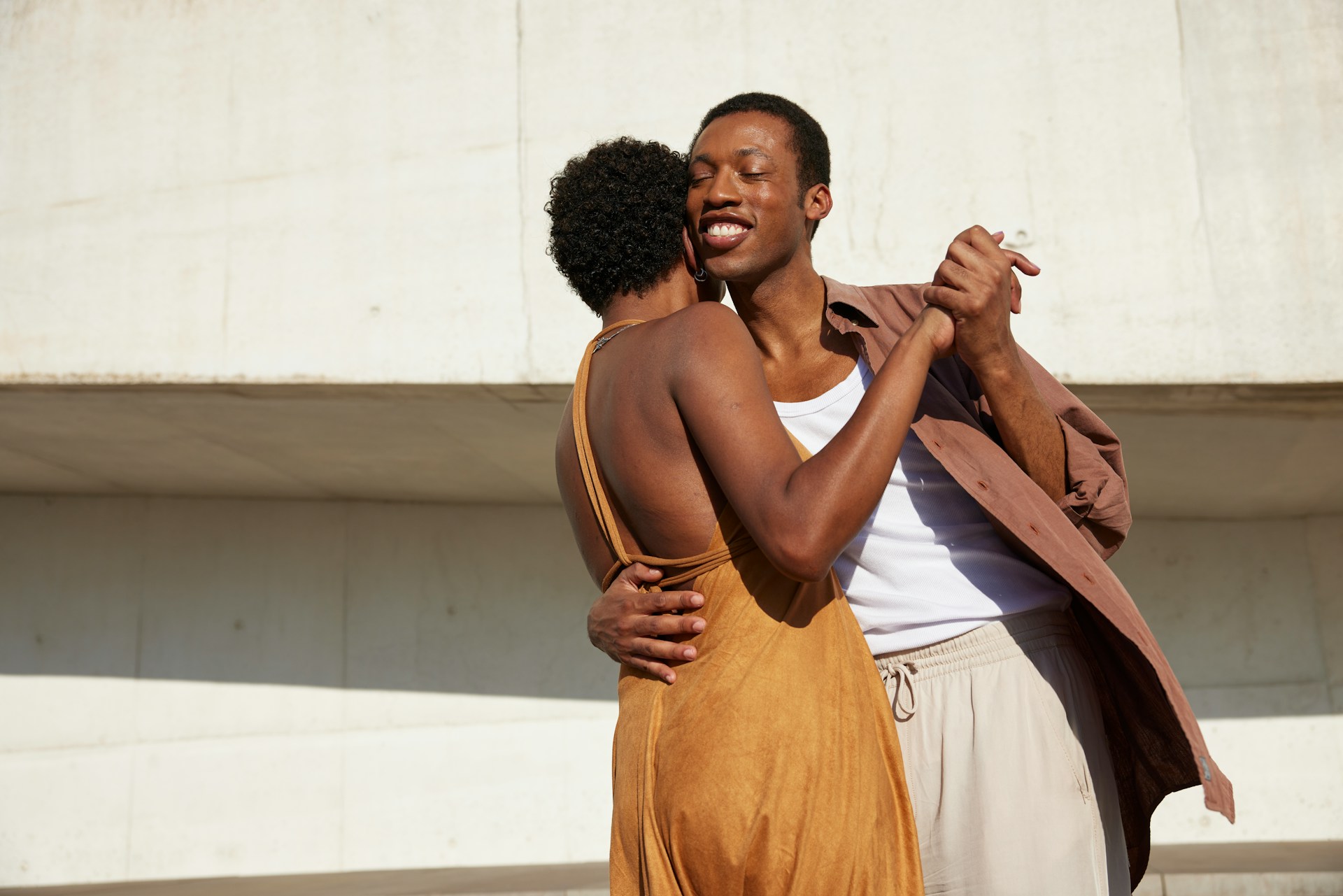 A black woman and man dance together